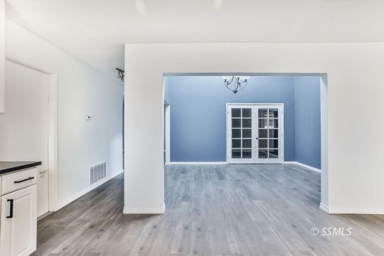 515 South Downs Street Ridgecrest, CA 93555 - Photo 10 of 31 an empty room with wooden floor and windows