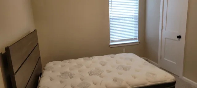 a close up of a bed in a small room