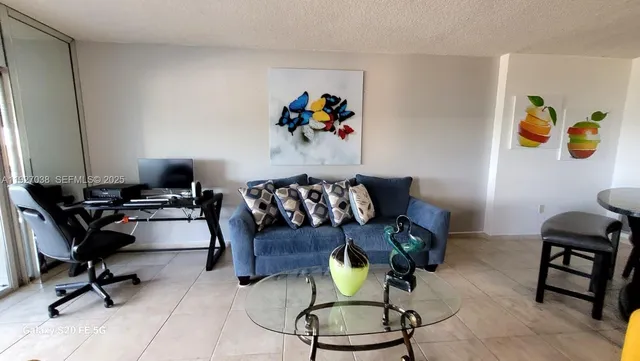 a living room with furniture and gym equipment