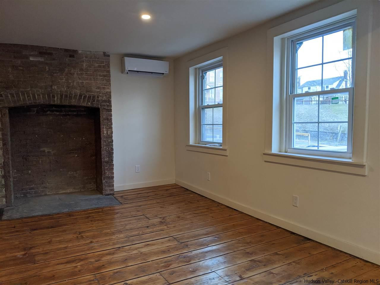 78-88 Spring Street Kingston, NY 12401 - Photo 11 of 34 an empty room with wooden floor and windows