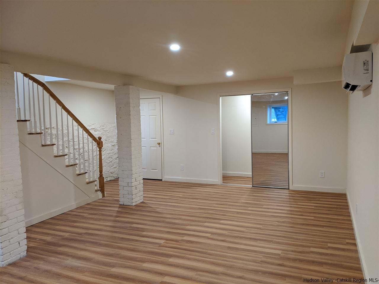 78-88 Spring Street Kingston, NY 12401 - Photo 16 of 34 a view of an empty room with wooden floor and stairs