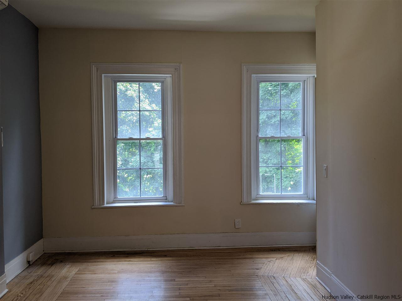 78-88 Spring Street Kingston, NY 12401 - Photo 28 of 34 an empty room with wooden floor and windows