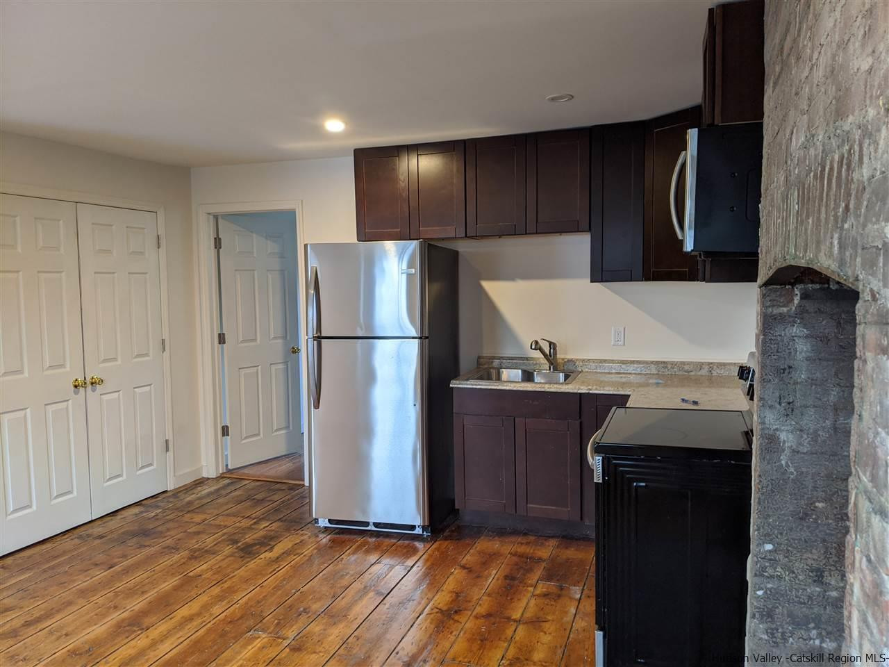 78-88 Spring Street Kingston, NY 12401 - Photo 10 of 34 a kitchen with a refrigerator and a stove