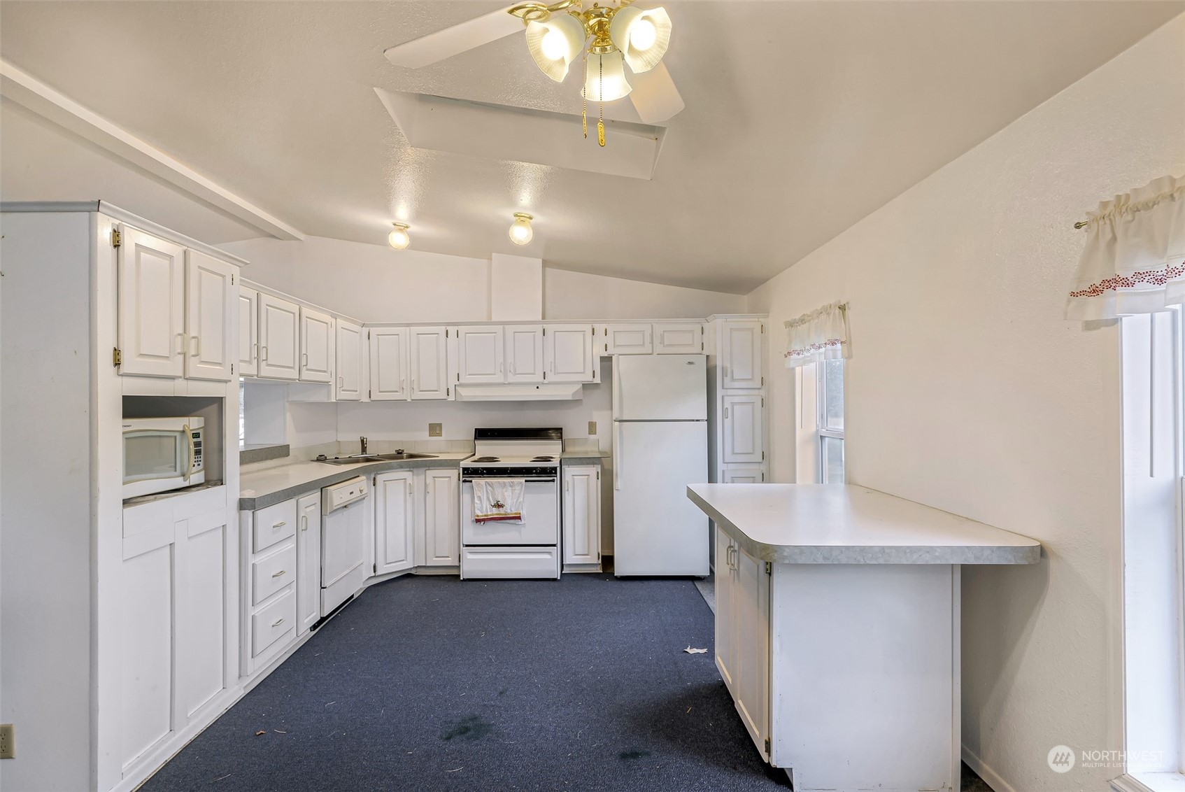 5020 Sand Road Bellingham, WA 98226 - Photo 3 of 16 a kitchen with white cabinets and stainless steel appliances