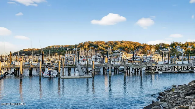 a kitchen with stainless steel appliances kitchen island granite countertop a sink a microwave a refrigerator and a stove