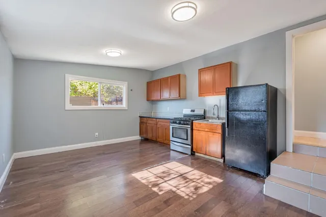 a kitchen with stainless steel appliances granite countertop a refrigerator sink and stove