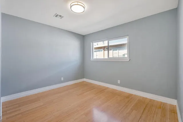 wooden floor in an empty room with a window