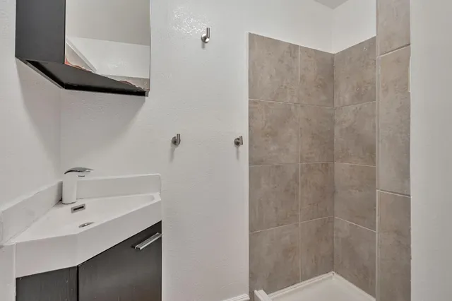 a bathroom with a sink and shower