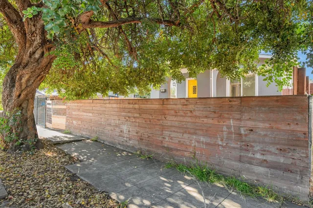 a view of a house with a tree