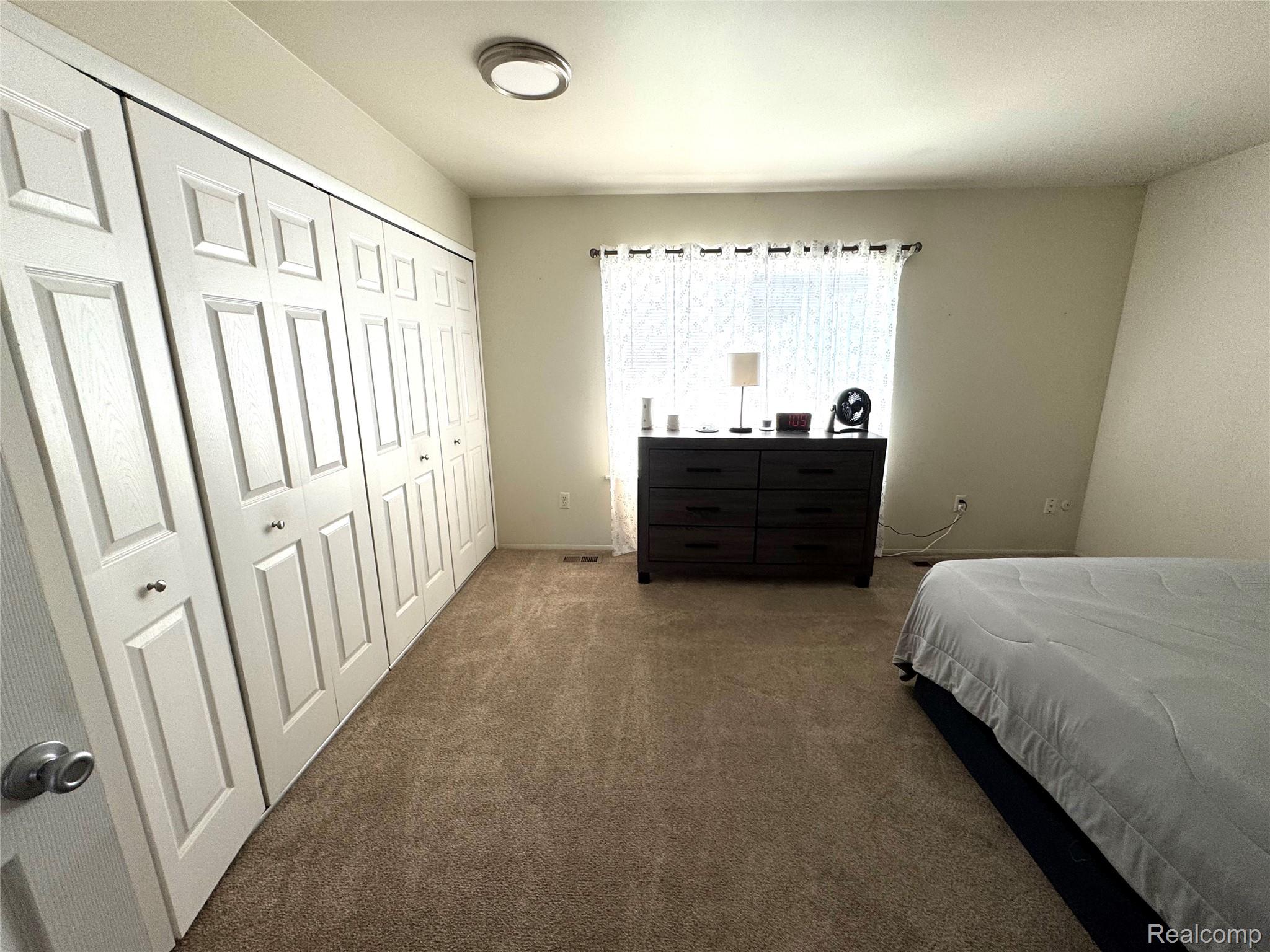 16285 Raleigh Square Drive Southgate, MI 48195 - Photo 22 of 25 Bedroom with dark colored carpet and a closet
