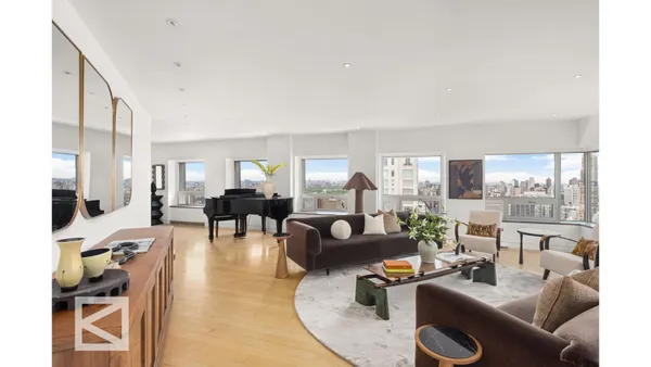 a living room with furniture and a chandelier