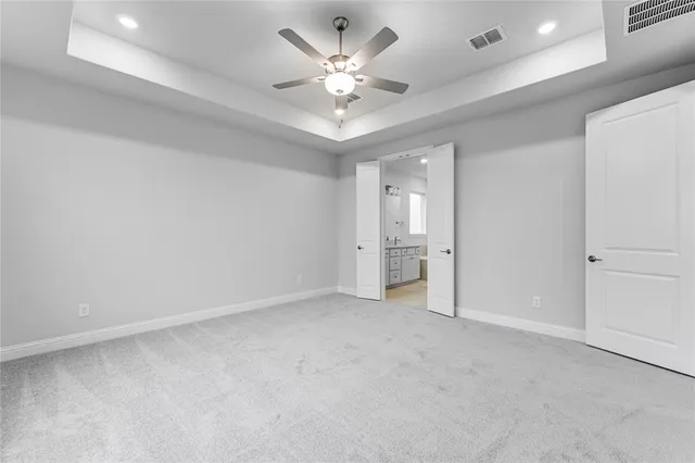 wooden floor in an empty room with a ceiling fan