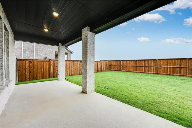 a view of a backyard with wooden fence