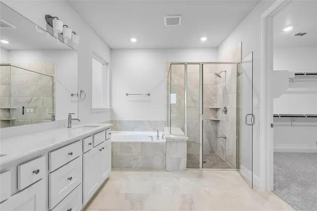 a spacious bathroom with a shower sink and mirror