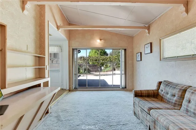 a bedroom with furniture and a large window