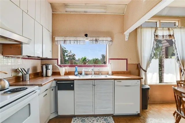 a kitchen with a sink cabinets and window