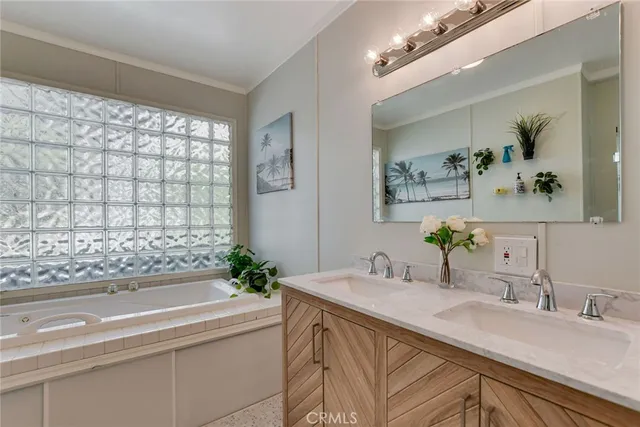 a bathroom with a granite countertop sink and a bathtub