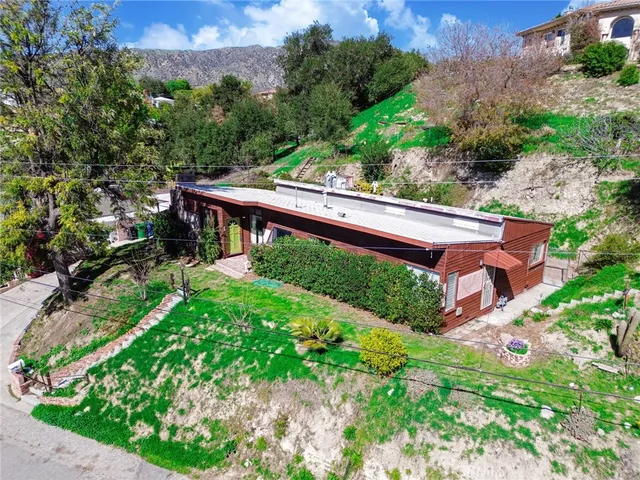 a living room with furniture a large window and a fireplace