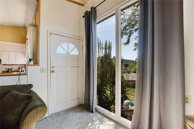 a bedroom with furniture and a large window