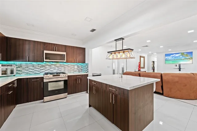 a kitchen with a stove top oven sink and cabinets