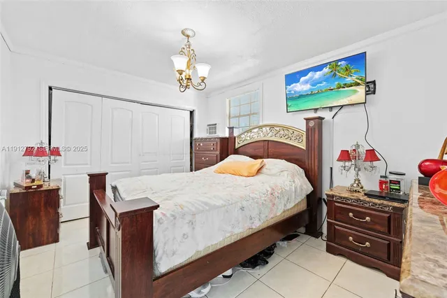 a bedroom with a bed and a chandelier