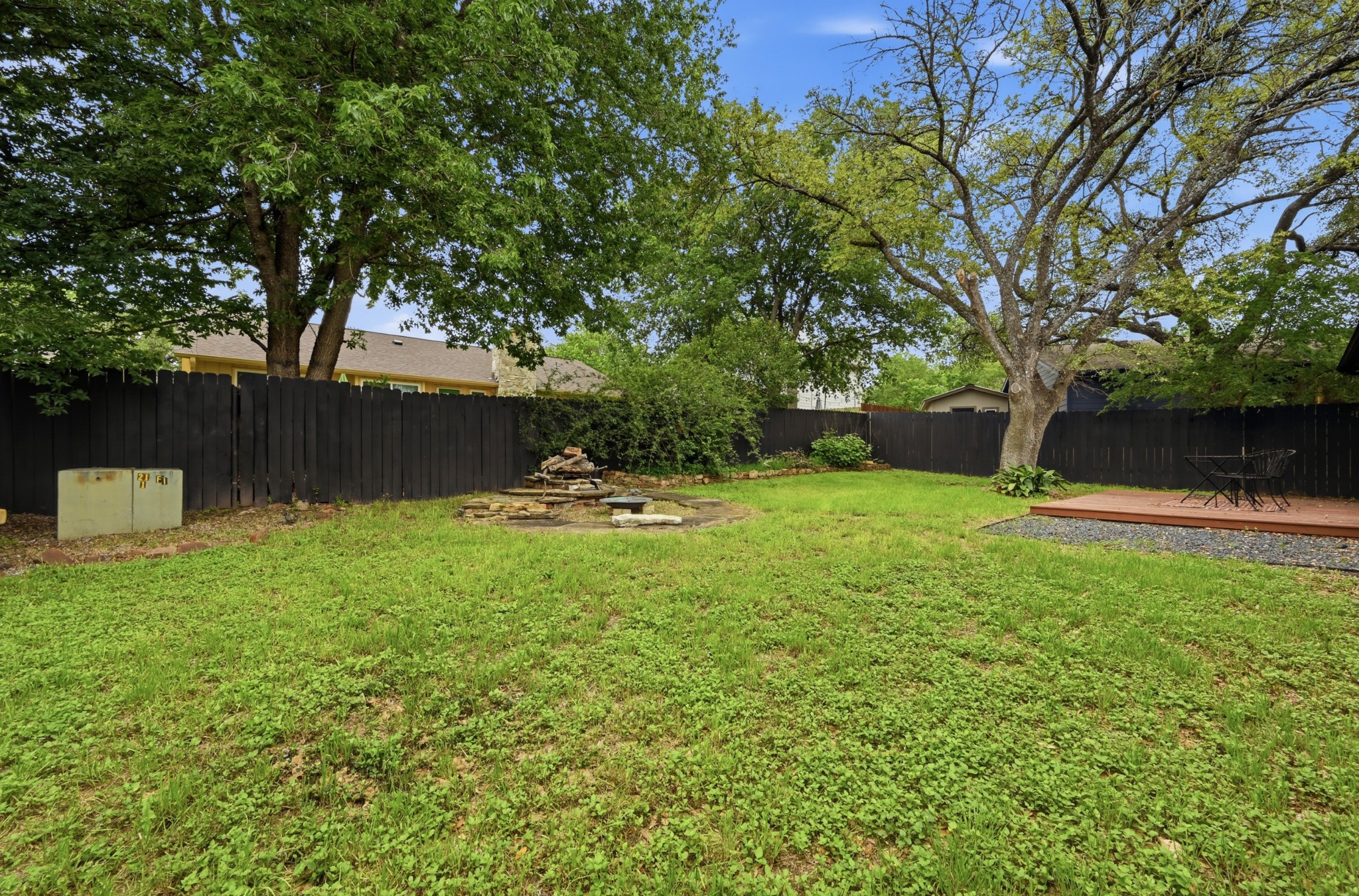 6805 Rearden Road Austin, TX 78745 - Photo 25 of 26 A spacious yard with mature trees offers a fire pit and a private deck.