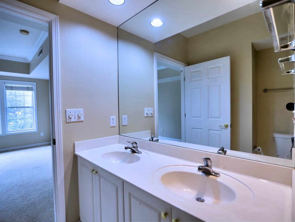 3636 Habersham Road Northwest, Unit 2308 Atlanta, GA 30305 - Photo 16 of 42 a bathroom with a sink and a mirror