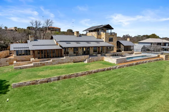 a front view of a house with a yard table and chairs