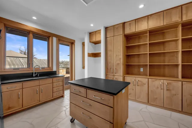 a kitchen with stainless steel appliances granite countertop a sink and a stove