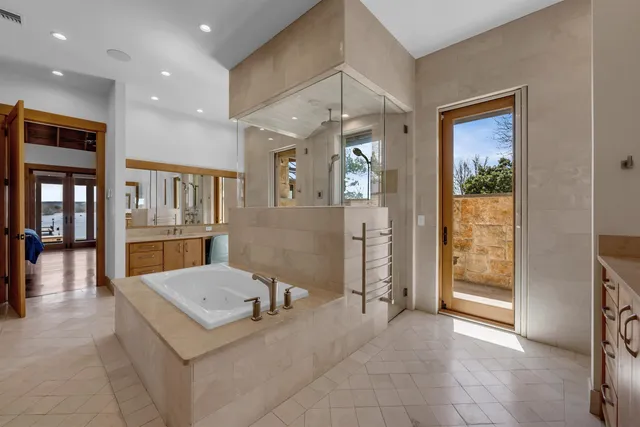 a view of a hallway with furniture and a large window
