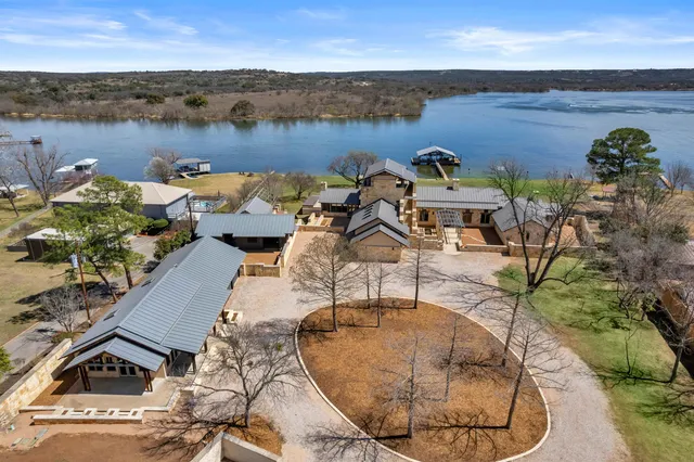 an aerial view of a house with outdoor space and lake view