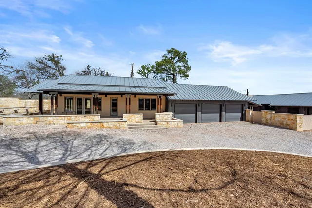 a kitchen with granite countertop a sink a stove and cabinets