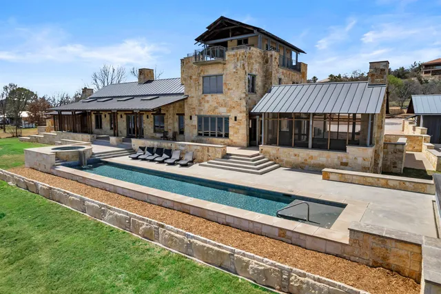 a front view of a house with a garden and patio