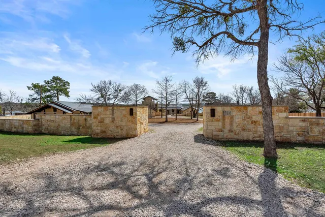 a view of a yard with car parked