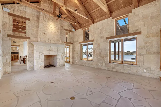 a view of an empty room with a fireplace