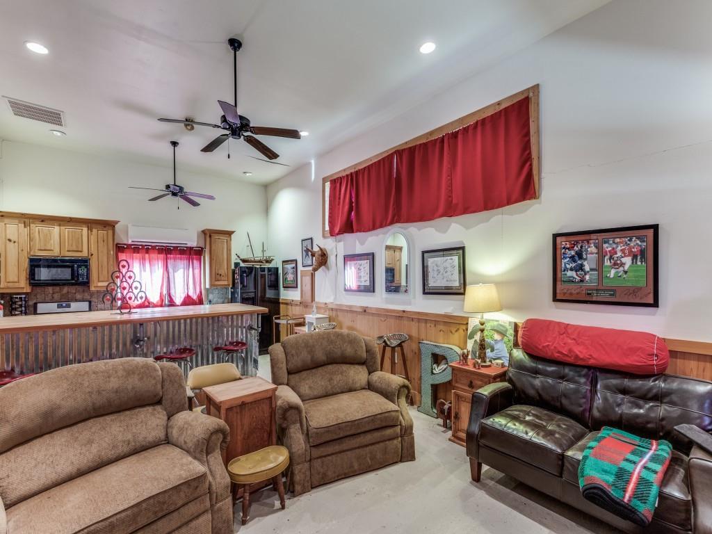 392 Mt Pleasant Road Valley View, TX 76272 - Photo 21 of 27 a living room with furniture a bed and a flat screen tv