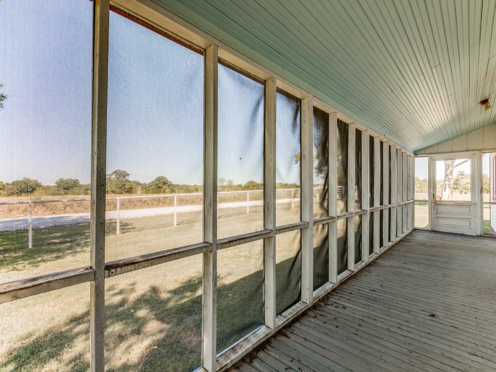 392 Mt Pleasant Road Valley View, TX 76272 - Photo 22 of 27 a view of an empty room with wooden floor and a window