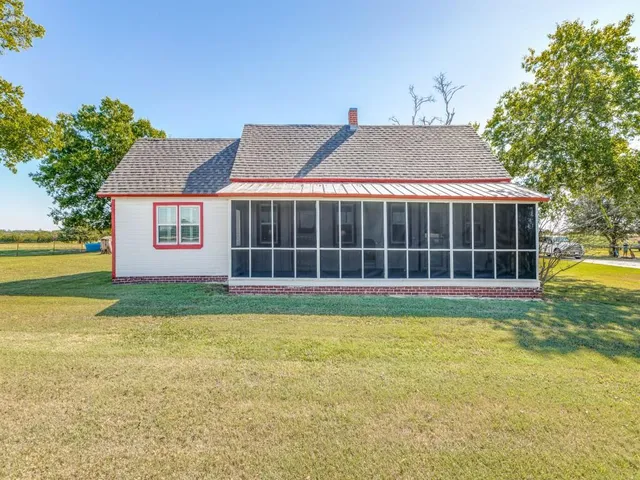 a view of a house with a yard and sitting area