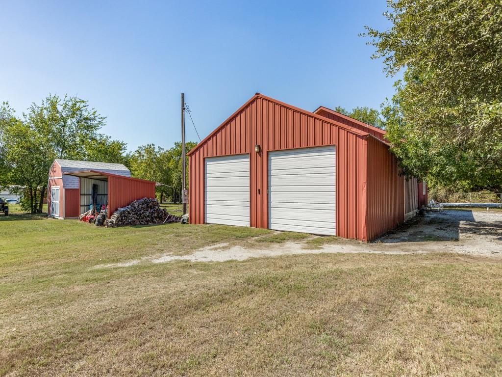 392 Mt Pleasant Road Valley View, TX 76272 - Photo 25 of 27 a front view of a house with a yard and garage