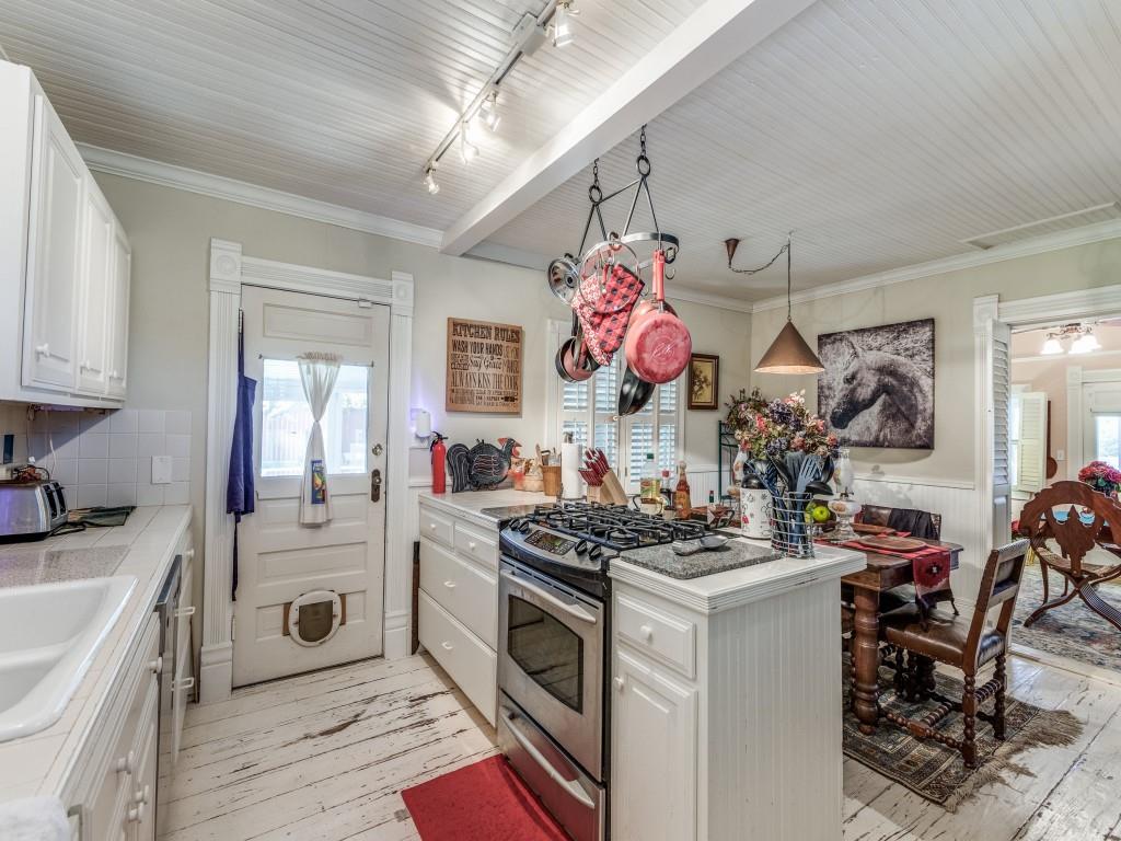 392 Mt Pleasant Road Valley View, TX 76272 - Photo 6 of 27 a kitchen that has a lot of white cabinets and stainless steel appliances