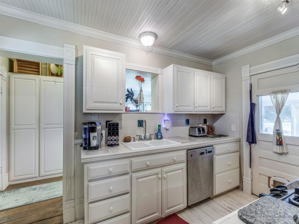 392 Mt Pleasant Road Valley View, TX 76272 - Photo 7 of 27 a kitchen with a sink dishwasher and cabinets with wooden floor