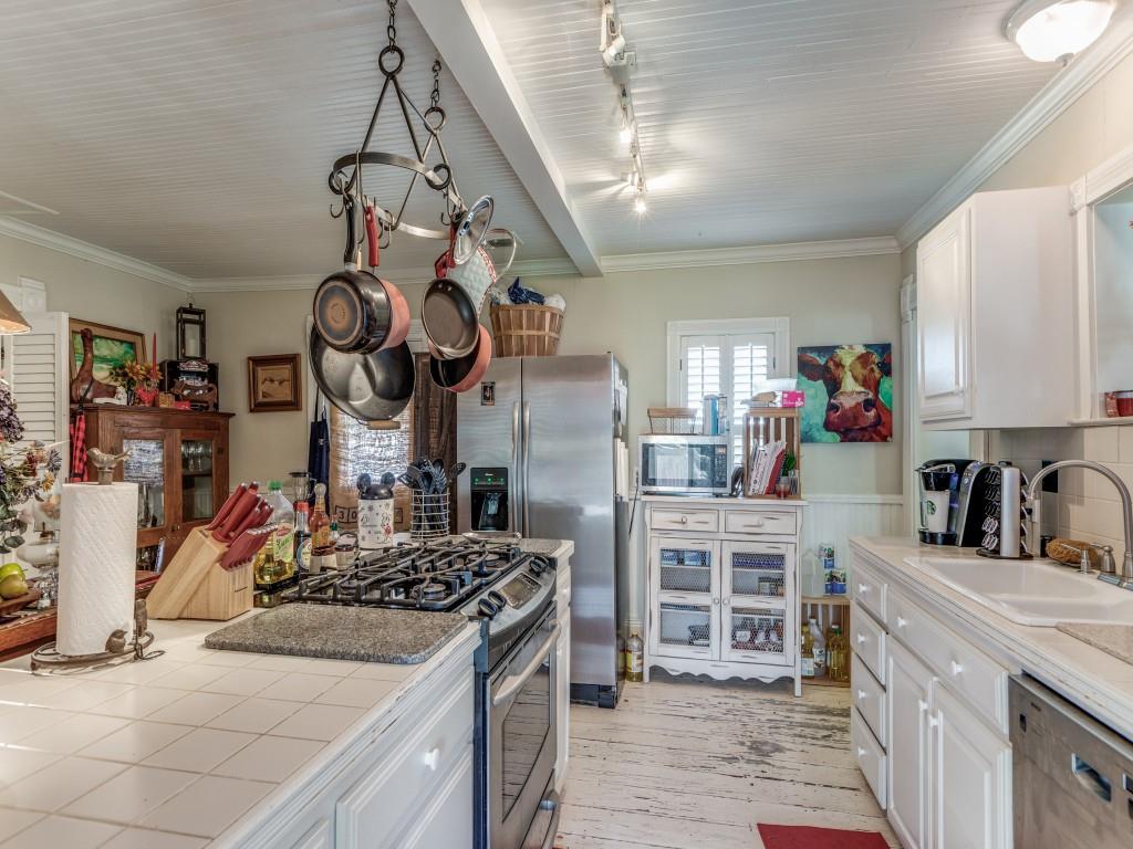 392 Mt Pleasant Road Valley View, TX 76272 - Photo 8 of 27 a kitchen with a stove and a white cabinets