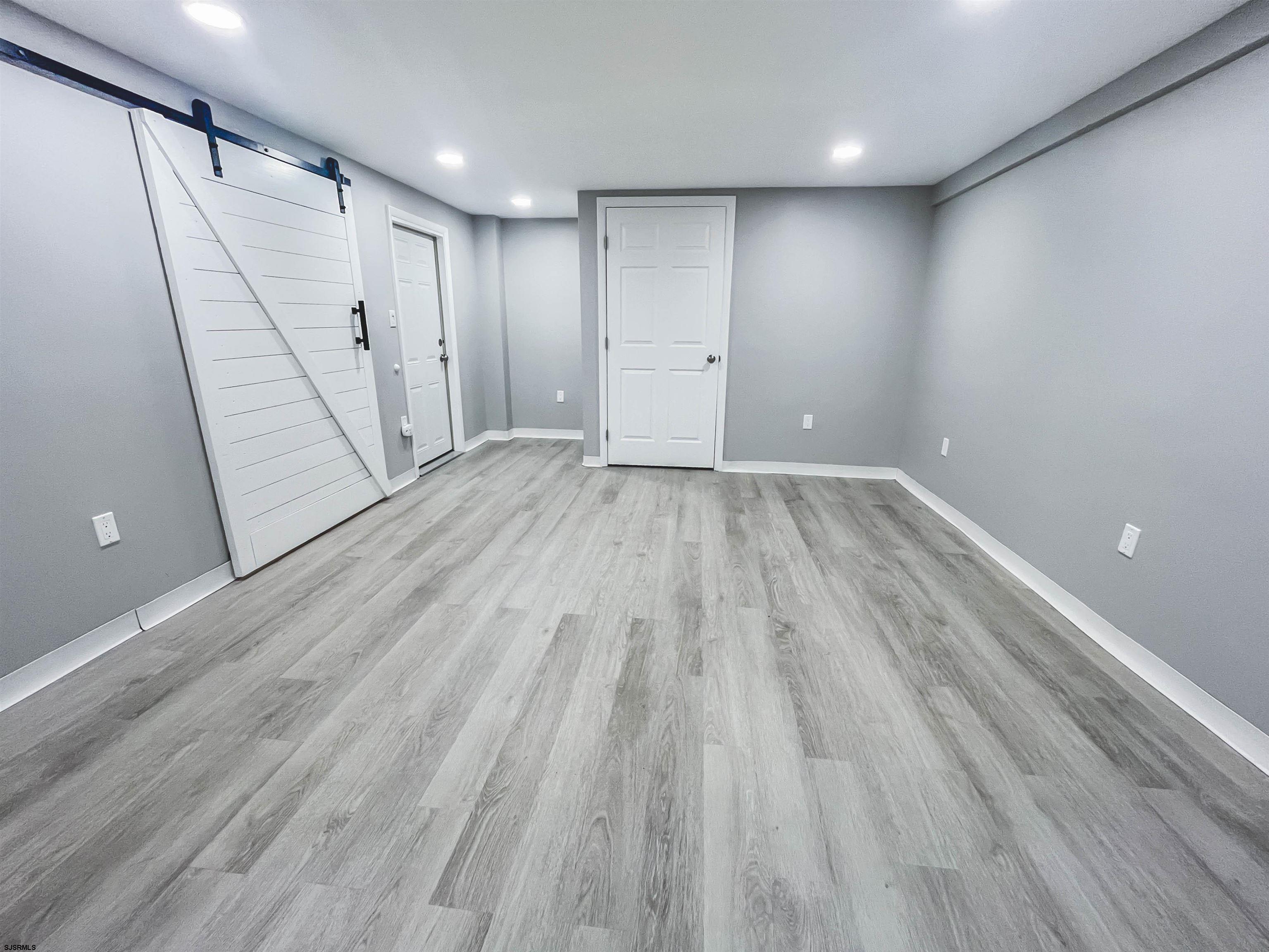 518 Delaware Avenue Absecon, NJ 08201 - Photo 25 of 38 a view of an empty room with wooden floor and a window