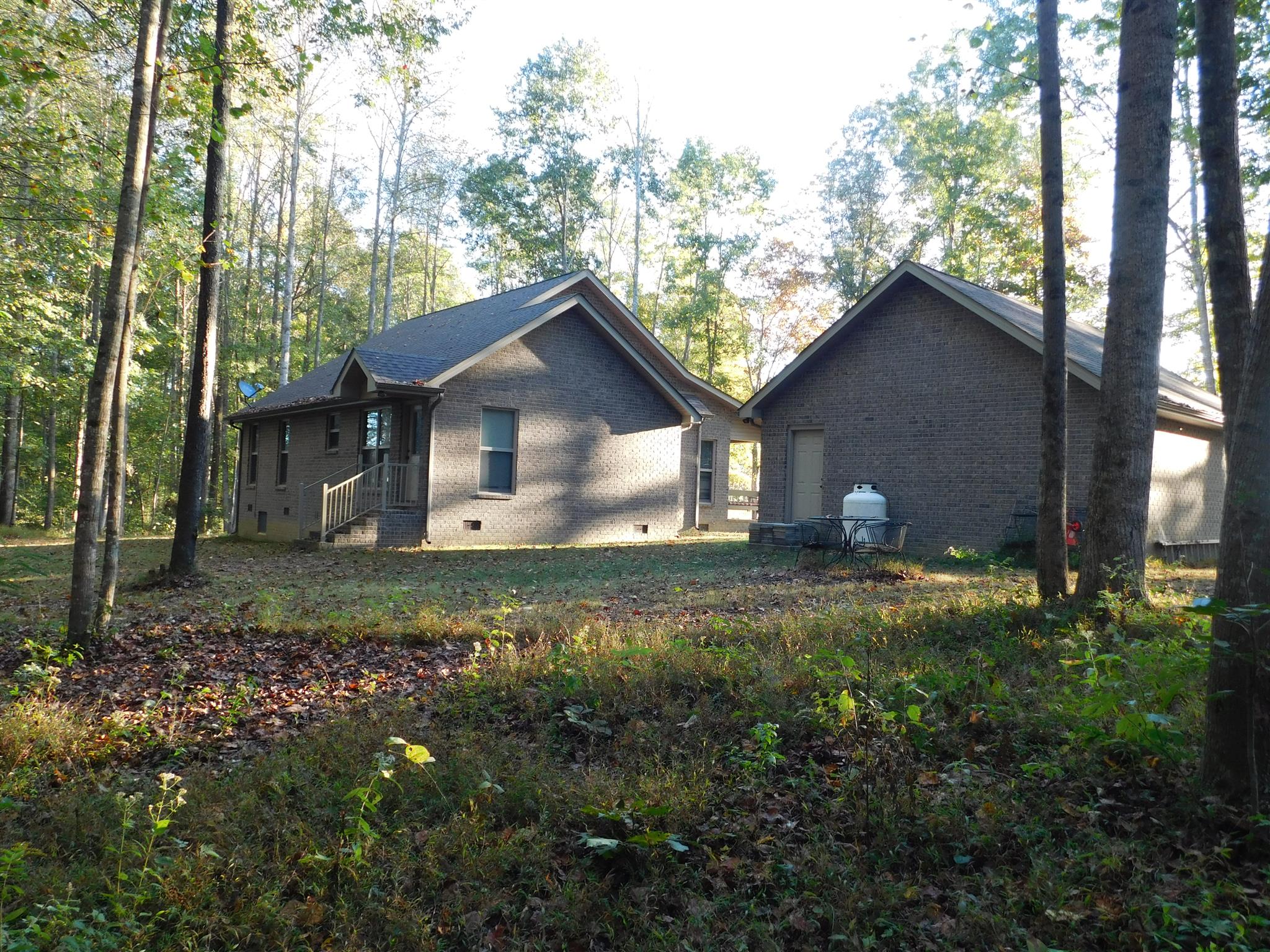 1705 Shaffer Road Manchester, TN 37355 - Photo 3 of 21 a view of a house with a yard and large trees