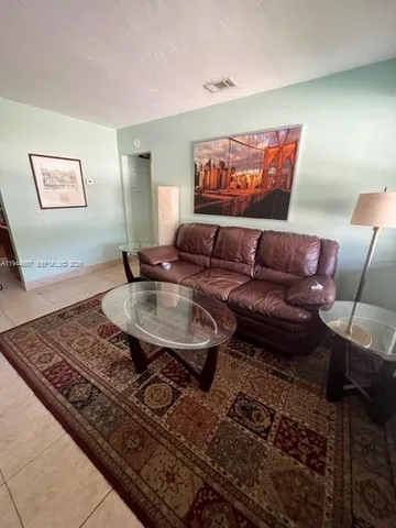 a living room with furniture and a rug