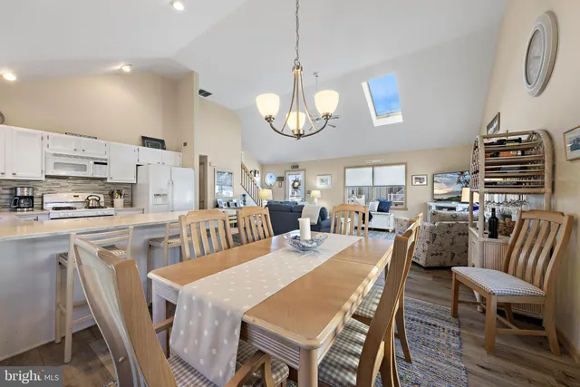 a very nice looking dining room with kitchen island a table and chairs