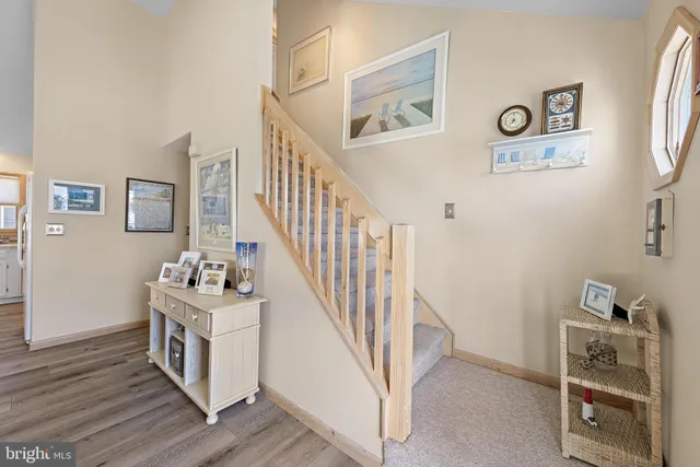 a view of a hallway with workspace and wooden floor