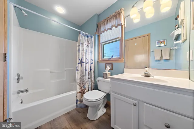 a bathroom with a sink a toilet and a bathtub