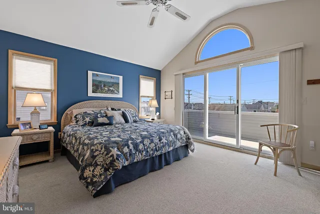 a spacious bedroom with a bed and a chandelier