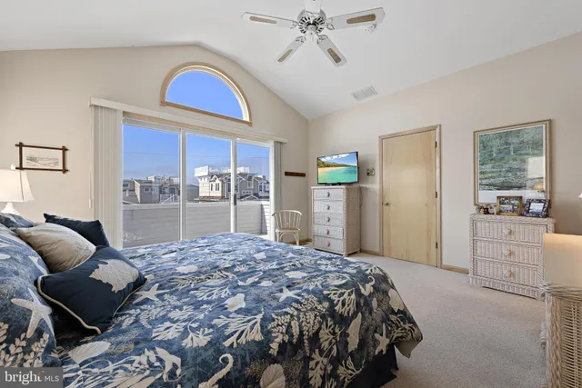 a bedroom with a bed and dresser with mirror